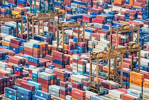 Singapore, Singapore - May 7, 2015: Piles of containers in the harbor of Singapore, the busiest asian commercial port