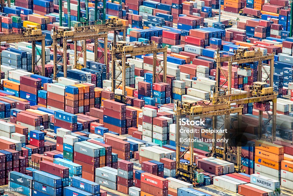 Piles of containers in the harbor of Singapore Singapore, Singapore - May 7, 2015: Piles of containers in the harbor of Singapore, the busiest asian commercial port Crowded Stock Photo
