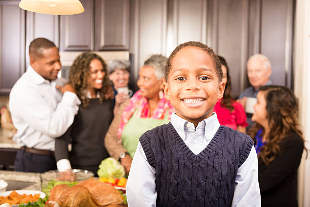 istock Thanksgiving:  Multi-generational family and friends gather in kitchen. 489350616