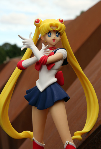 Vancouver, Canada - September 14, 2015: A figurine of  Usagi Tsukino, also known as Sailor Moon, from the Sailor Moon animated TV series.  Tsukino is a carefree schoolgirl who can transform into Sailor Moon, the de facto leader of the Sailor Soldiers, a group of warrior women. She is posed against a background in the city of Vancouver, Canada. The figurine is made by Banpresto 