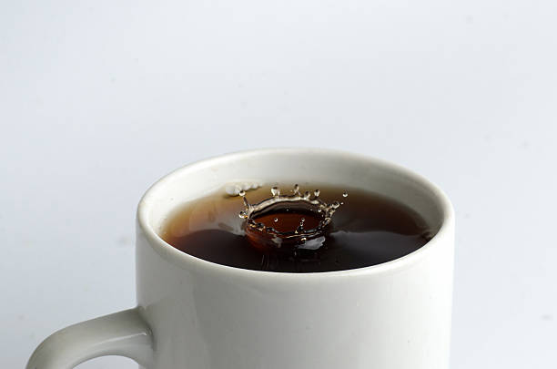 istock Cup of tea with water splash on white background 489350840