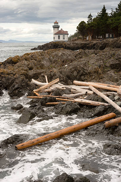 Lime Kiln Lighthouse Haro Strait Maritime Nautical Beacon Canada can be seen across the straight from San Juan Island lime kiln lighthouse stock pictures, royalty-free photos & images