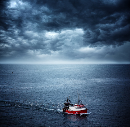 fishing boat returning home before sea storm. Southwest Ireland. Note to inspector: photo is stitched.