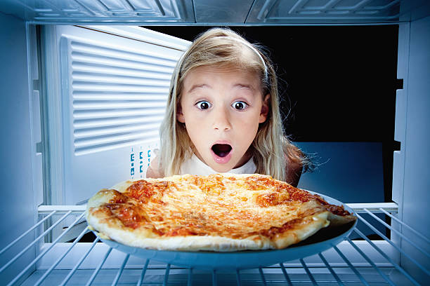 istock girl found pizza in fridge 489355075