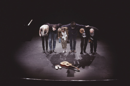 actors bow to thank the audience  on stage