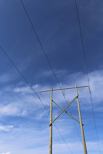 istock High voltage power transmission lines against blue sky 489356071