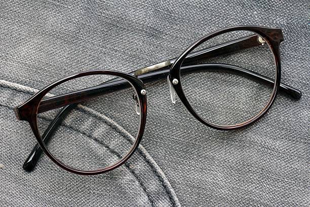 istock Nerd glasses isolated on blue jeans background. 489359119