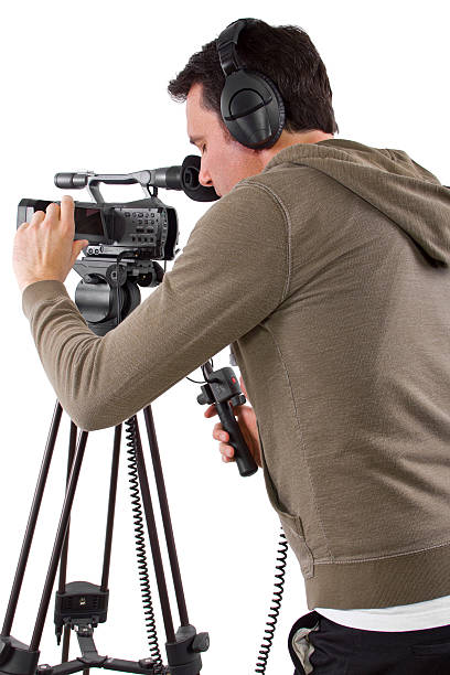 Camera Man Wearing Headphones with a Camera and Tripod