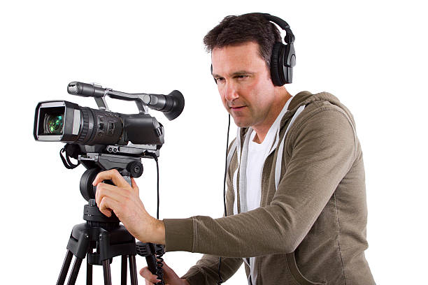 istock Camera Man Wearing Headphones with a Camera and Tripod 489362405