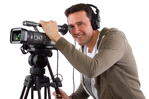 istock Camera Man Wearing Headphones with a Camera and Tripod 489362411