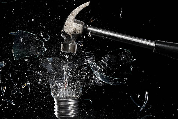 smashing a light bulb stock photo