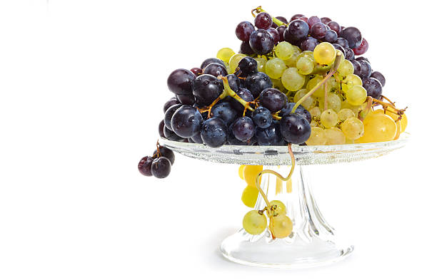 istock white and black grapes in a glass bowl  on white 489375036