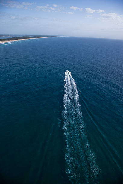 istock Small motor boat sailing towards an island 489377614