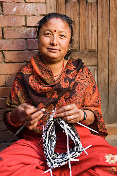 istock Nepali woman  kniting wool hat. Bhaktapur. 489377784