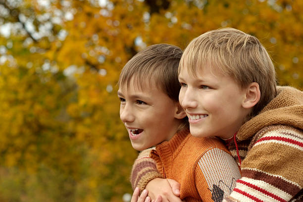 istock Boys  in autumn park 489383140
