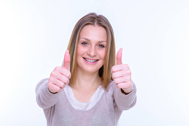 istock happy beautiful girl with braces 489383210