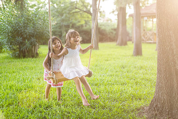 Little girl having fun on a swing outdoor