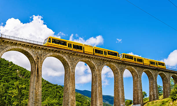 The Yellow Train (Train Jaune) on Sejourne bridge The Yellow Train (Train Jaune) on Sejourne bridge - France, Pyrenees-Orientales pirineos stock pictures, royalty-free photos & images
