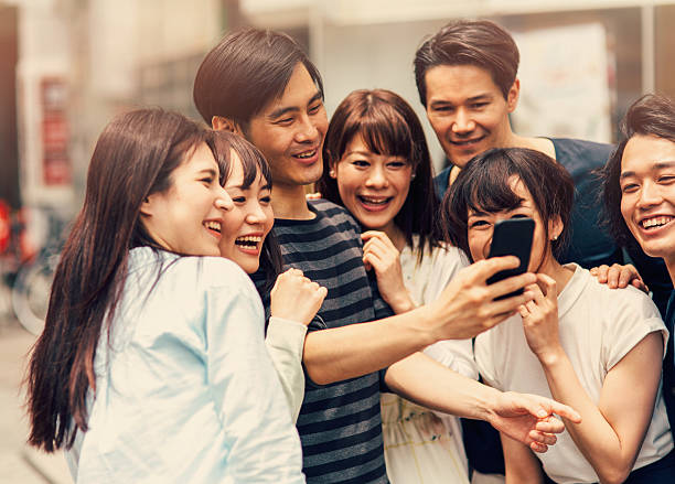 istock Happy japanese friends taking a selfie 489386170