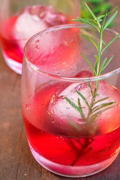 istock Glasses of refreshment raspberry flavour fizz with ice and rosem 489389118