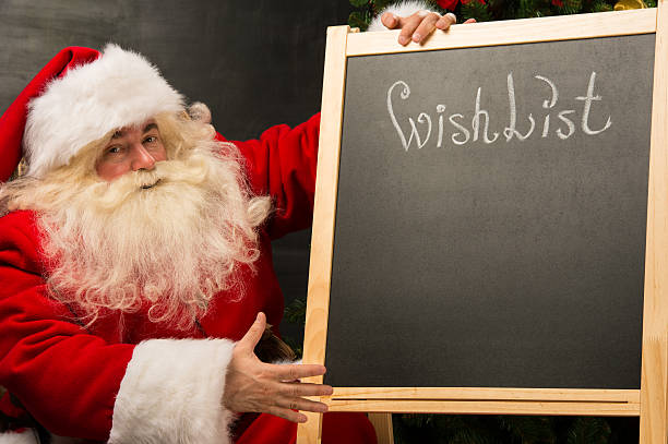 istock Santa Claus sitting near chalkboard 489424522