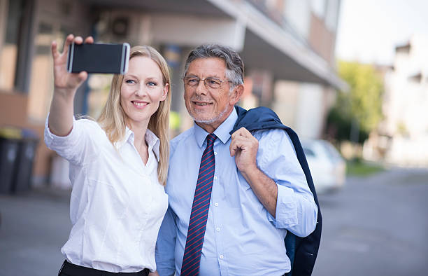 istock Two business people taking a selfie with smart phone 489424584