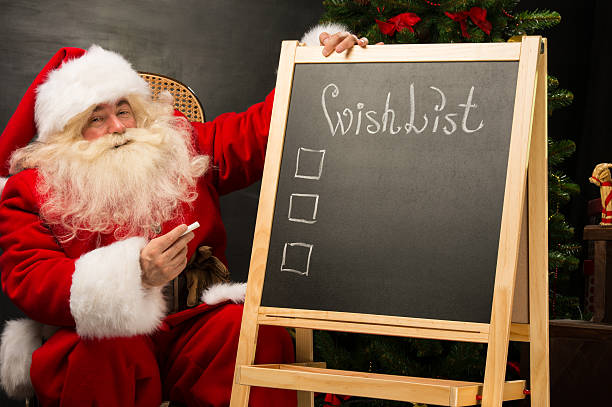 istock Santa Claus sitting near chalkboard 489424922