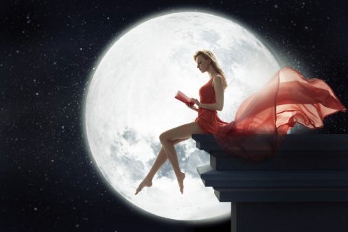 Cute lady over full moon background