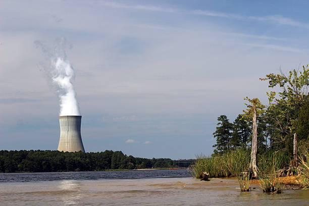 istock Cooling Tower of Nuclear Power Plant with Lakeside in Foreground 489426558