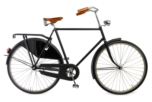 Black retro styled bicycle with brown leather saddle and steering grips isolated on a white background.