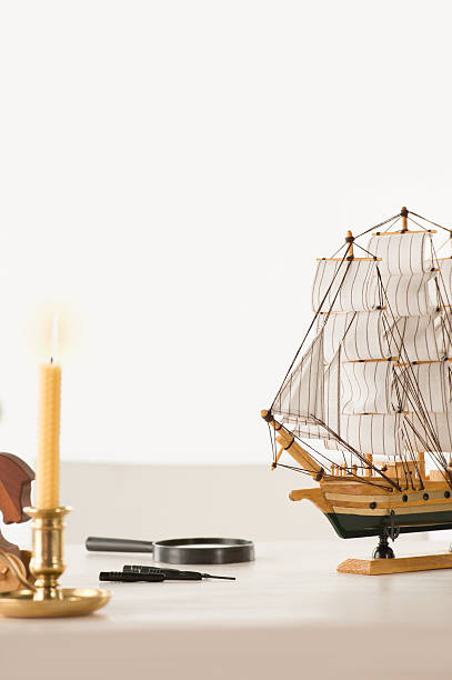 istock Wooden ship toy model on white table against white background 489426582