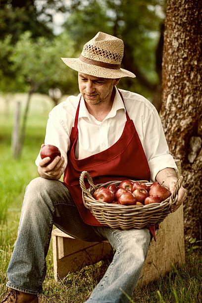 istock fruit grower in his orchard tasting apple harvest 489426605