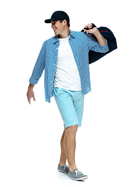 istock Happy young man walking with duffle bag 489427099
