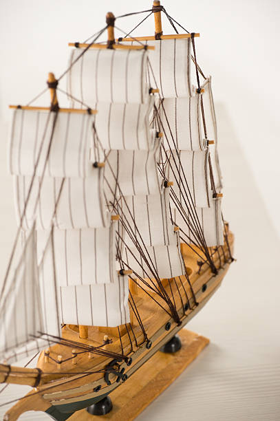 istock Wooden ship toy model on white table against white background 489427866