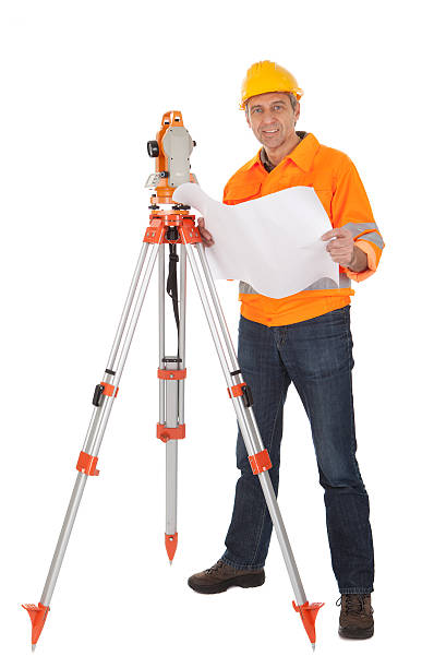 Senior land surveyor with theodolite Portrait of Senior land surveyor working with theodolite. Isolated on white tripod attack stock pictures, royalty-free photos & images