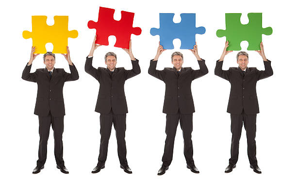 istock Group of business people holding jigsaw puzzle 489428329