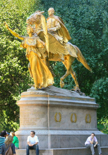 New York, NY, USA - October 20, 2007: Sculpture of General William Sherman. It was designed by sculptor Augustus St.Gaudens and erected in 1903. The statue is located at Grand Army Plaza at the southeast entrance of the Central Park. People are resting on the statue's base and walking around.