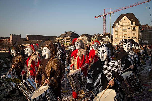 Basel Carnival Basel, Switzerland - March 10, 2014: Group of so called Waggis with drums walking through the streets at the Basel carnival. fastnacht stock pictures, royalty-free photos & images