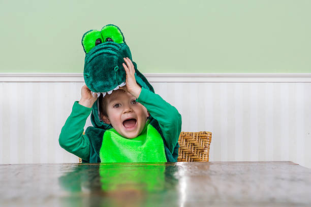 Cute child in crocodile suit Adorable little boy in a crocodile suit crocodile photos stock pictures, royalty-free photos & images