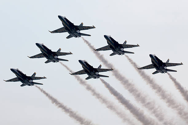 The Blue Angels, also referred to as the U.S. Navy Flight Demonstration Squadron, four Boeing FA-18 Super Hornets having just performed a loop against a clear blue sky at an air show at the Naval Air Facility,  El Centro, California.  Photography date: March 16, 2019.