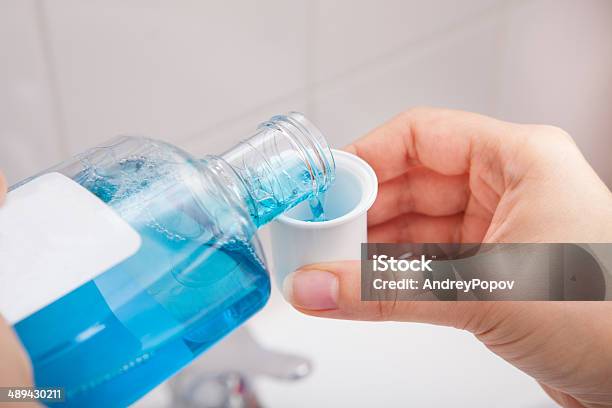 Person Pouring Liquid In Container Stock Photo - Download Image Now - Mouthwash, Washing, Women