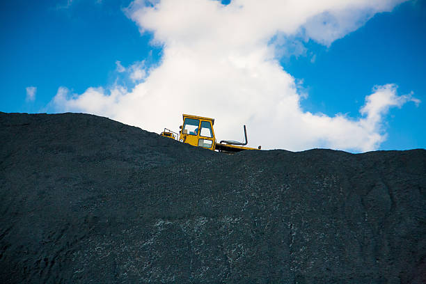 bulldozer on a coal mining pile stock photo