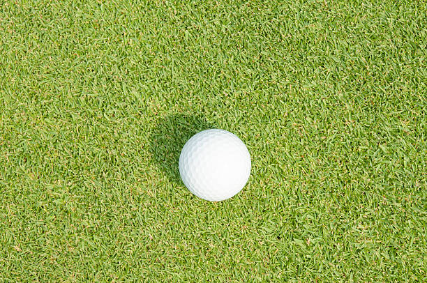 istock Golfball on grass infront of the green 489431883
