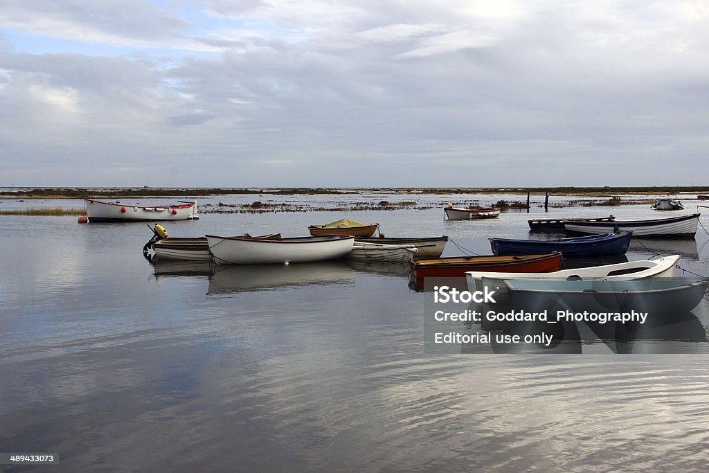 England: Blakeney Harbour in Norfolk Morston, England - October 18, 2012: Small boats moored at Blakeney Harbour in Norfolk. The harbour is part of the Norfolk Coast AONB (Area of Outstanding Natural Beauty) and the North Norfolk Heritage Coast. The harbour and surrounding marshes are owned by the National Trust and is a nature reserve where seals can be seen basking on the sand. Blakeney Stock Photo