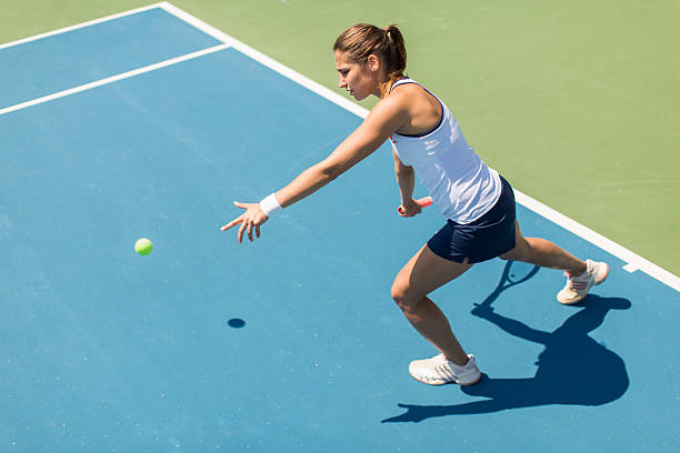 istock Young woman playing tennis 489433190