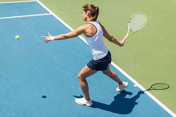 istock Young woman playing tennis 489433300