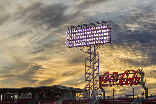 Boston MA, United States - September 21, 2015: The sun sets at Fenway Park in Boston MA behind the giant Coca Cola sign.