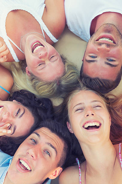 istock Group of young people lying down in a circle. 489436122