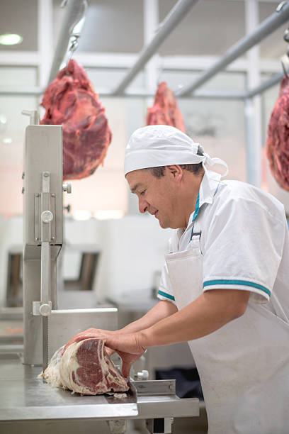 istock Butcher cutting meat at the butchery 489436130