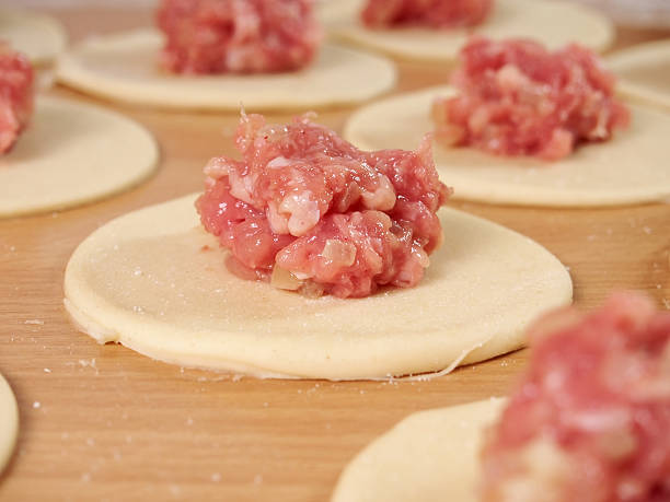 istock Mince on dough circle. Preparation Meat Dumplings. 489436400